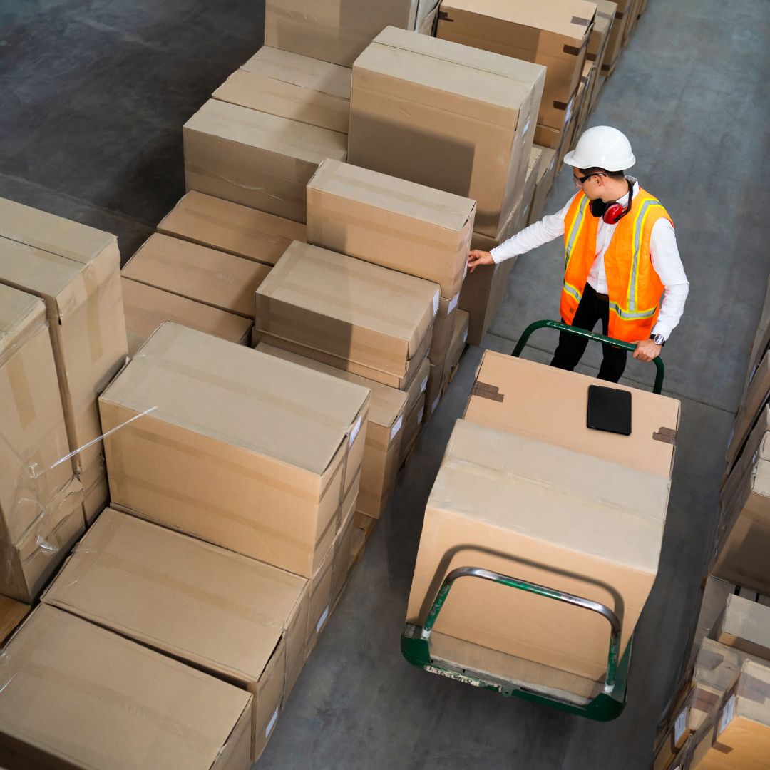 worker walking down row of packages