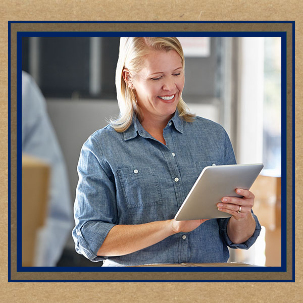 woman smiling at ipad