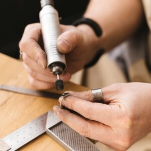 person using an adhesive to bond metal