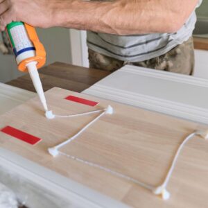 adhesive being put on wood