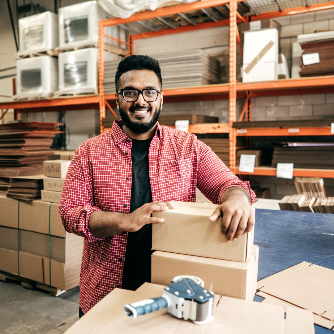 man packaging box smiling